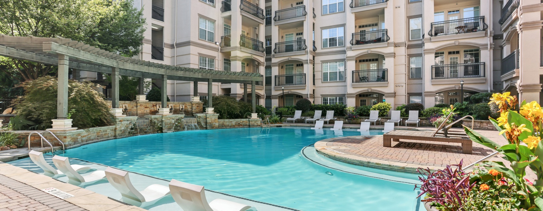Resort-style pool with sundeck & pergolas at Avana Uptown apartments in Atlanta, GA