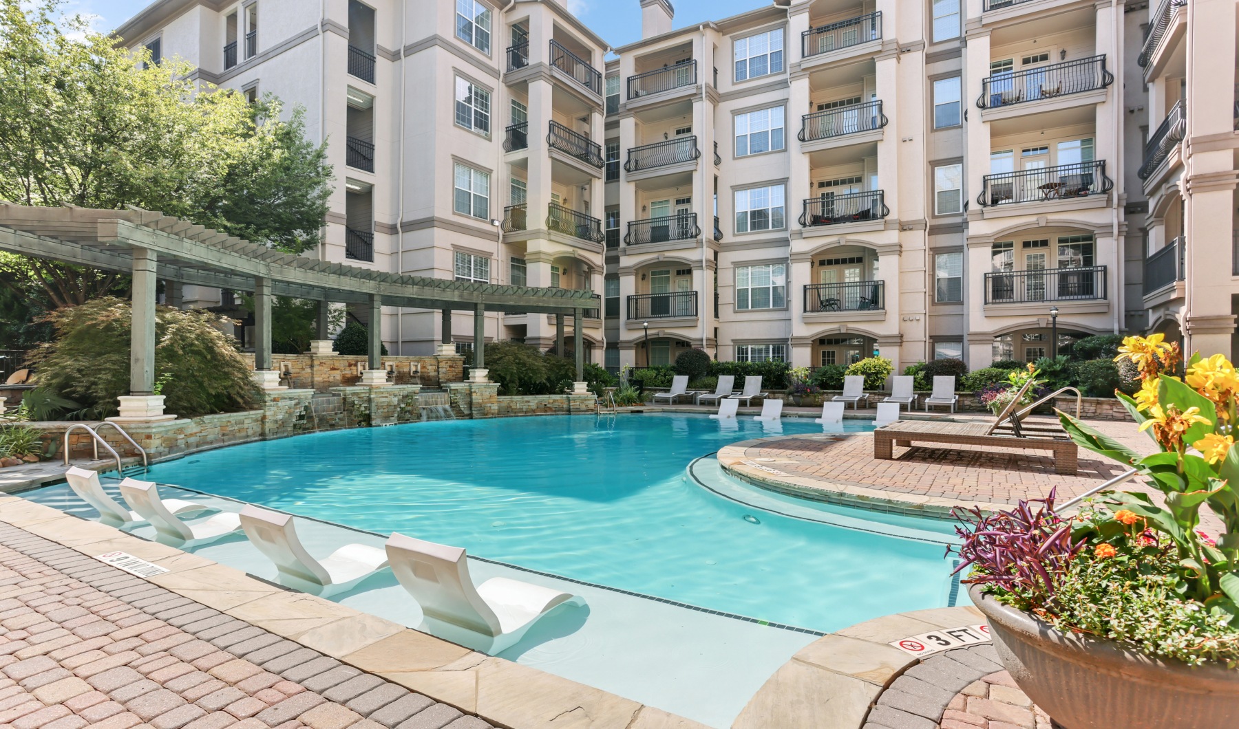 Resort-style pool with sundeck & pergolas at Avana Uptown apartments in Atlanta, GA