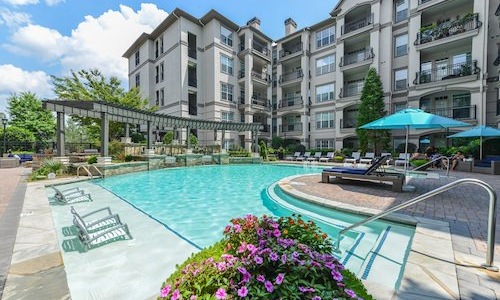 swimming pool with lounge chairs nearby